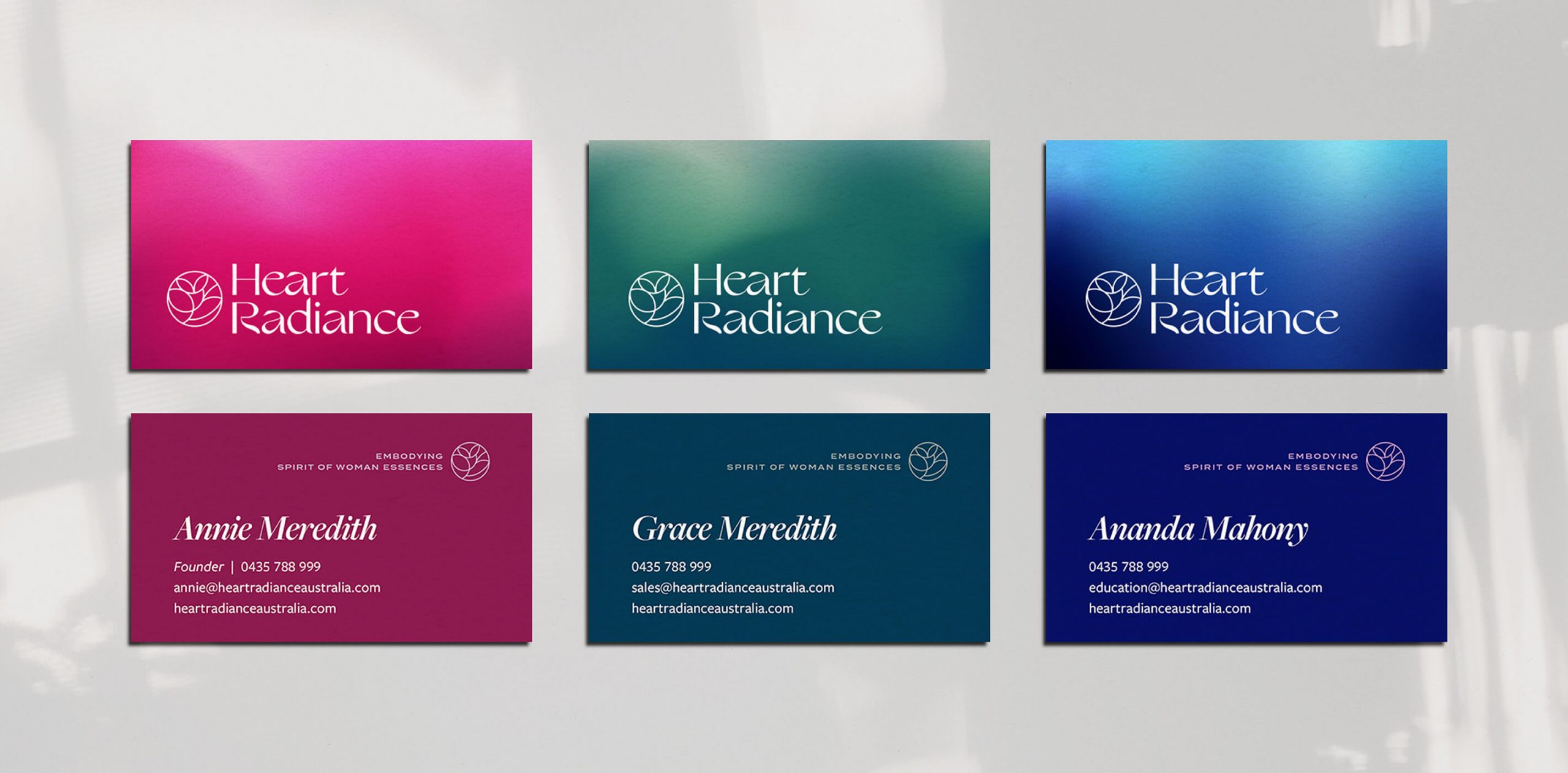 Rebranding case study image of the HeartRadiance business cards. Each card features the logo on one side and details on the other- each with a different of the brand gradients.