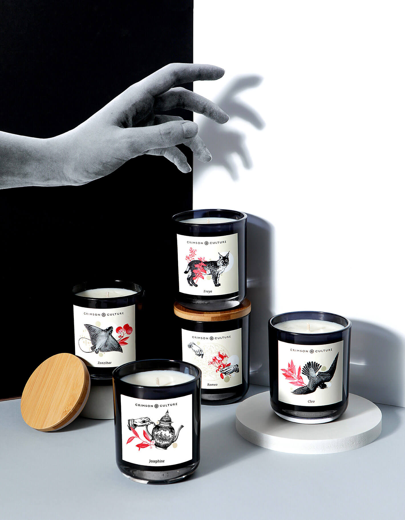 Art directed campaign image showing candle range with new labelling and collaged paper hand interacting with scene