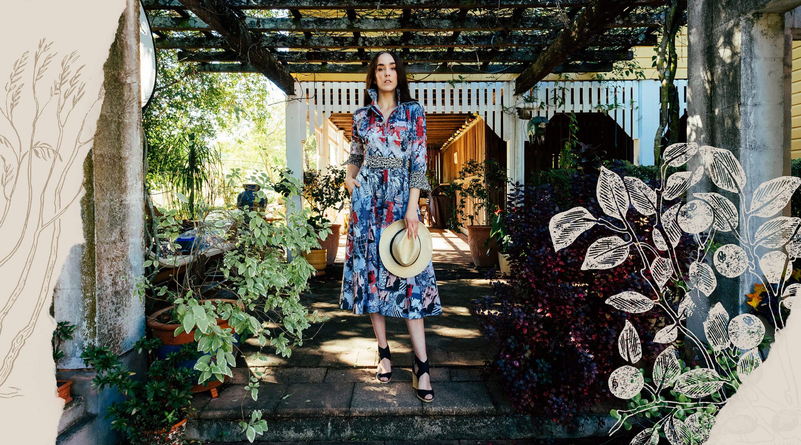 Astille campaign image for Rodin's Garden collection has woman in lush garden in patterned dress with hat
