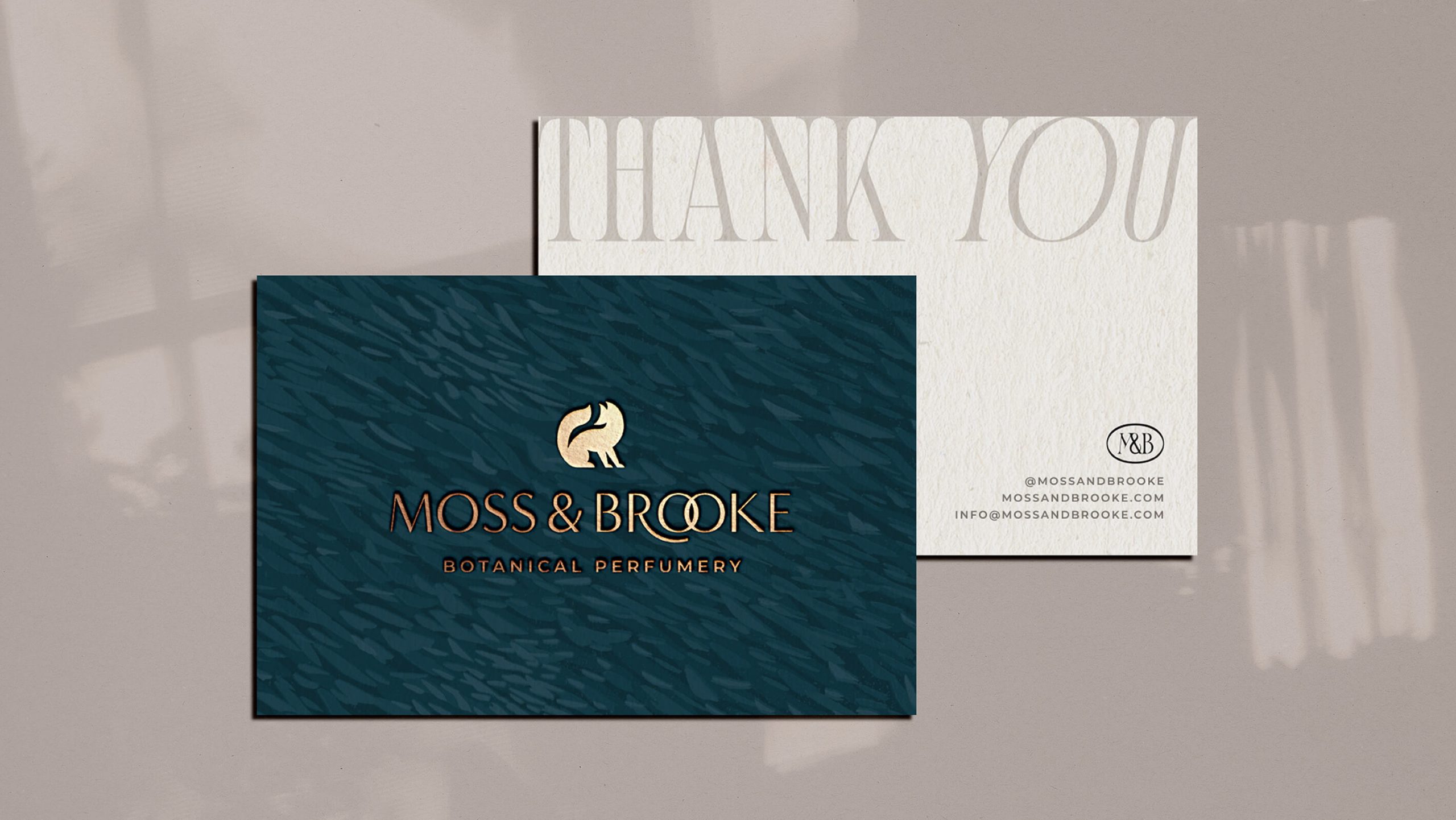 unique strategic brand identity design for botanical perfumery moss and brooke. The gold foil custom thank you cards feature linoprint textures, elegant typography and a fox icon