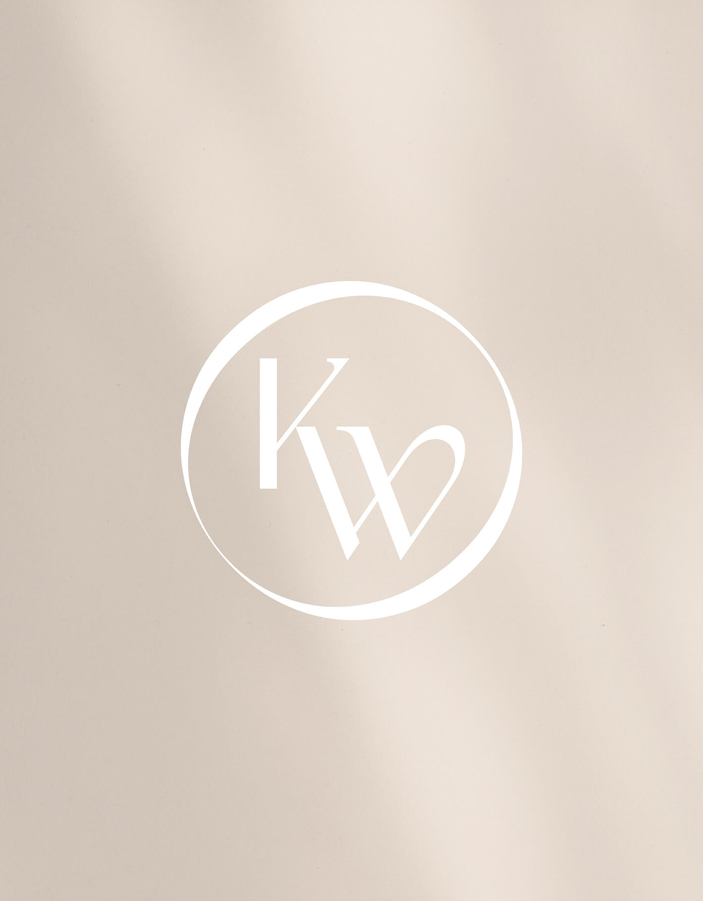 On a pale background sits the custom kelly woodcroft fashion designer brand seal in white