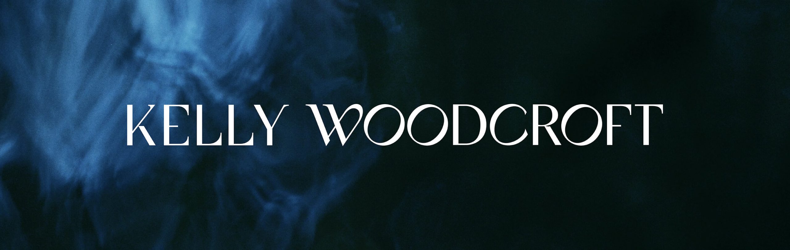 The sophosticated logo design for Kelly Woodcroft sits on a deep blue background