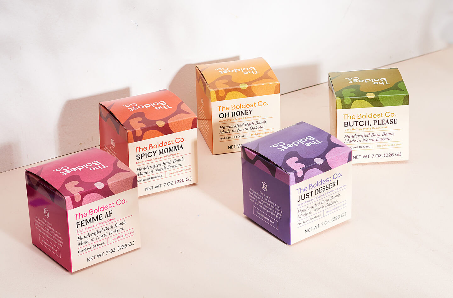 Brand design portfolio cover image showing the range of The Boldest Co soap boxes in a light cream setting. The boxes showcase the vintage-inspired blobby patterns and clean typography.